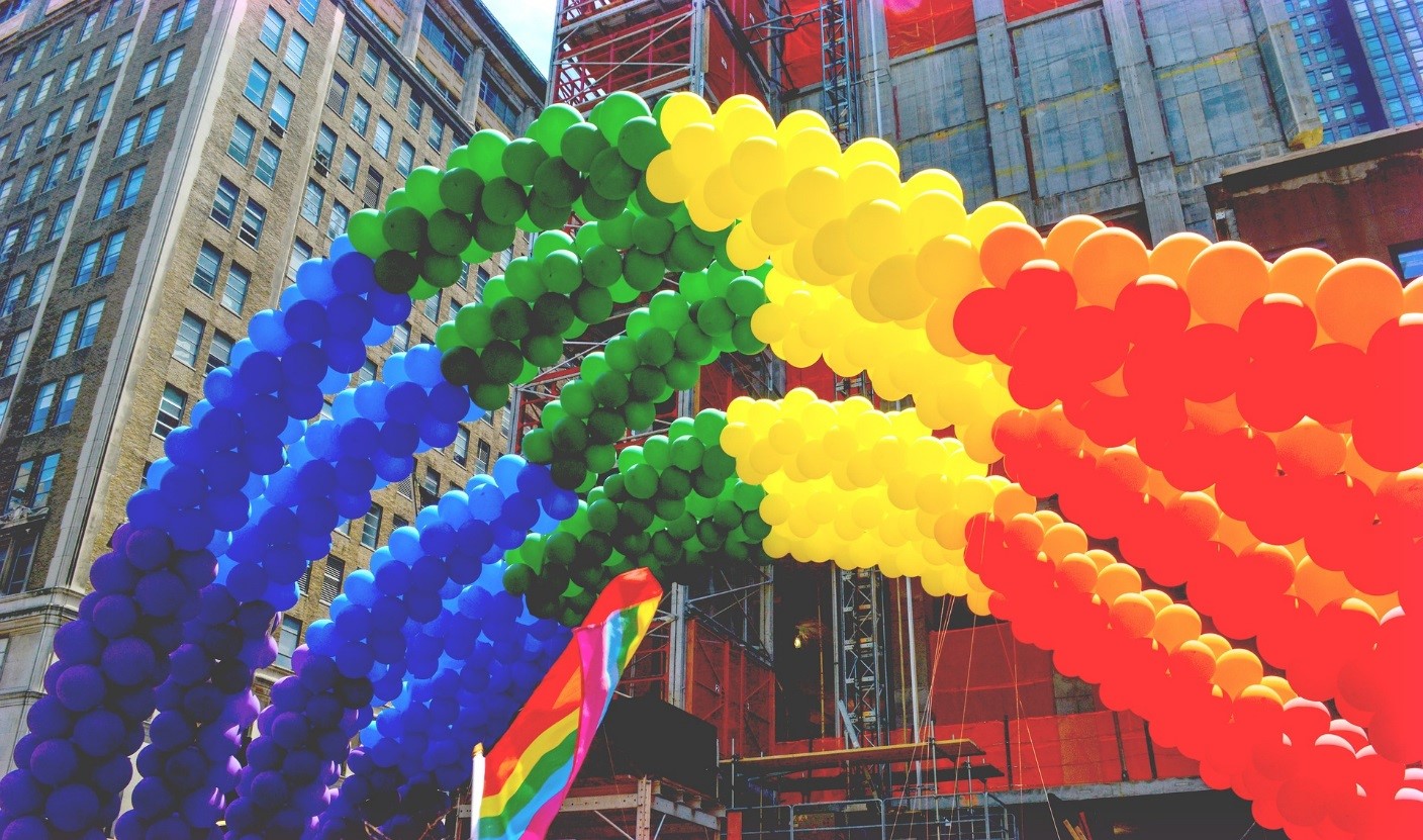 An archway made of balloons in the rainbow colours